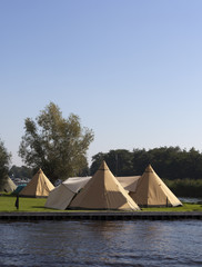 tipi tents on a dutch camping with blue sky