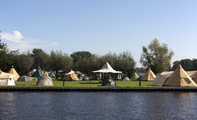 tipi tents on a dutch camping with blue sky
