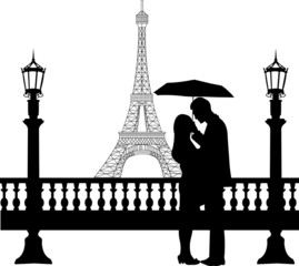 Romantic couple in front  Eiffel tower in Paris under umbrella