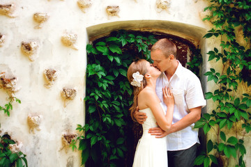 Bride and groom posing near castle