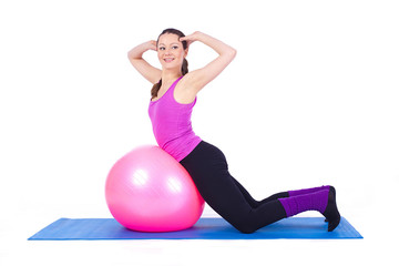Fototapeta premium healthy young woman exercising with fit-ball in gym