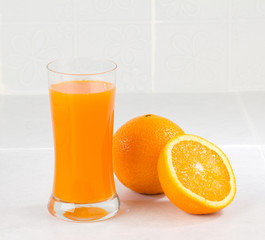 Sliced orange and a glass of orange juice