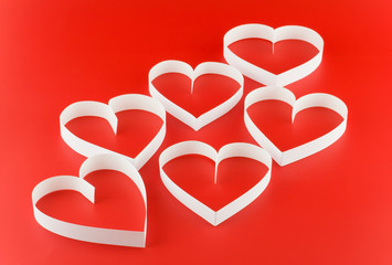 A lot of hearts  on red background.