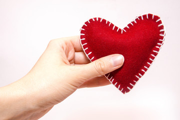 Red heart in hand
