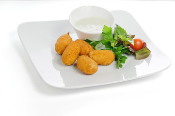 Chili cheese nuggets with tomatoes and greens