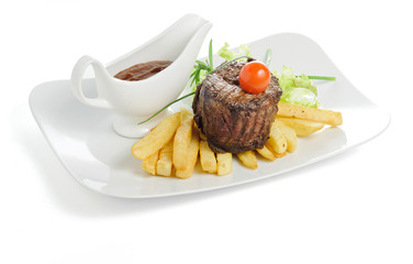 Grilled meat with fries and sauce