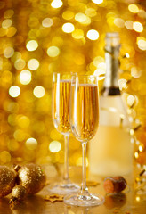 Two glasses of champagne with a Christmas decor .