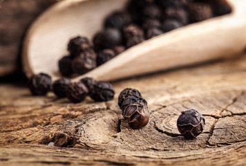 Black pepper on the rustic old wooden table