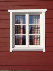 white window on red house