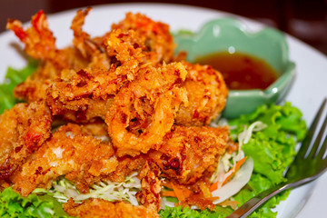 Deep fried squid rings on the plate with salad