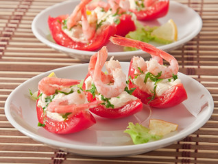 Halves of tomatoes filled with shrimp cocktail 