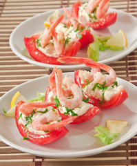 Halves of tomatoes filled with shrimp cocktail 