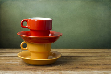 Colorful coffee cups on wooden table