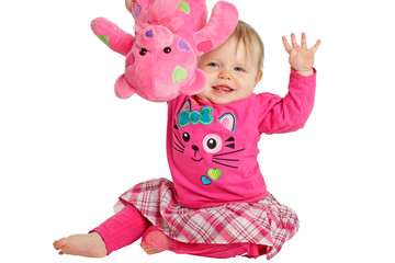 Happy baby girl waves pink teddy bear