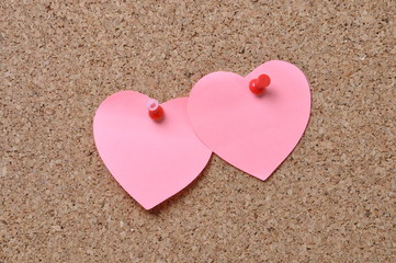 Pin board with piece of paper in the shape of heart
