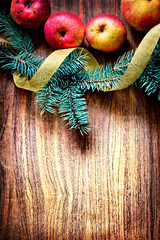 christmas tree with apples and decorations on a wooden board