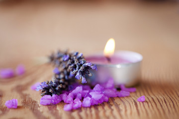 Fototapeta na wymiar Candle with salt baths and sprigs of lavender