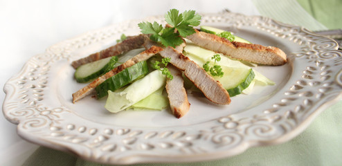 Fresh salad with grilled meat stripes