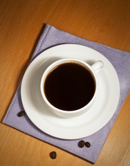 White coffee cup and saucer on a napkin