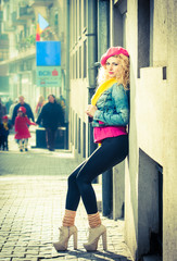 Young fashion woman with pink basque walking at the street