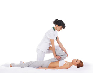 A young redhead woman getting a traditional Thai massage