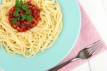 Italian spaghetti in plate on wooden table