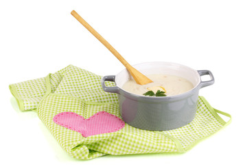 Mashed potatoes in saucepan on green pinafore isolated on white