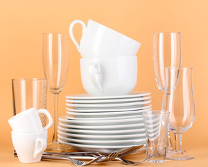 Clean white dishes on beige background