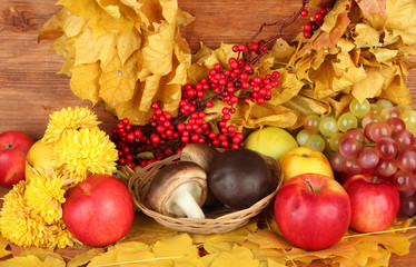 Autumnal composition with yellow leaves, apples and mushrooms