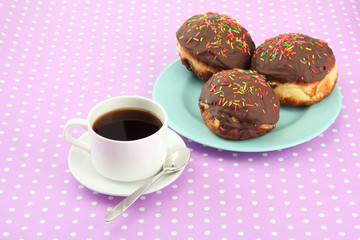 Tasty donuts on color plate on color background