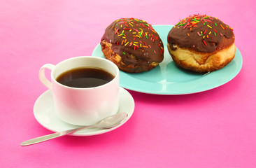 Tasty donuts on color plate on color background