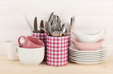 Cups, bowls nd other utensils in metal containers isolated