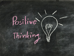 the word positive thinking and light bulb drawn on a chalk board