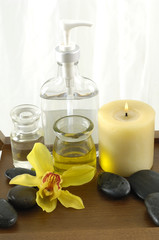 bottle of aromatherapy oil and orchid