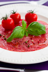 Carpaccio with basil and tomatoes