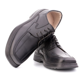 Black glossy man’s shoes with shoelaces