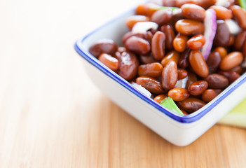 Salad of boiled haricot on a wooden surface