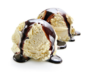 Two ice cream scoops with chocolate sauce