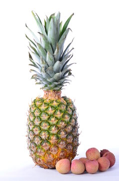 Pineapple and Lychees on white background