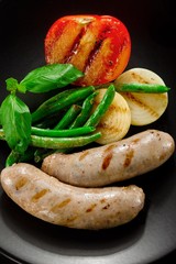 Sausages and fried tomatoes.
