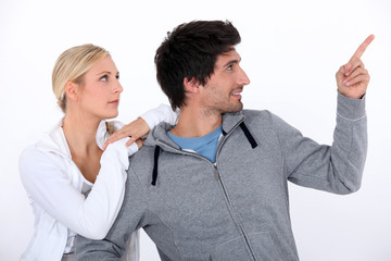 Joggers looking at an aeroplane in the sky