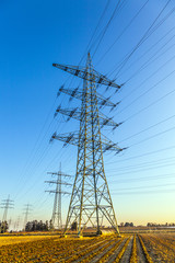 hight voltage tower in rural landscape with blue sky
