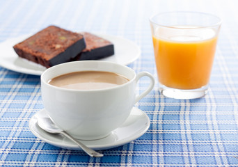 Breakfast with coffee, orange juice and chocolate cake