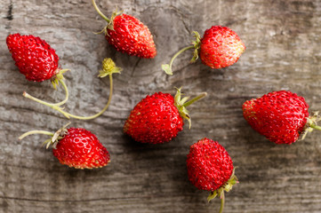 Wild strawberries on wooden background