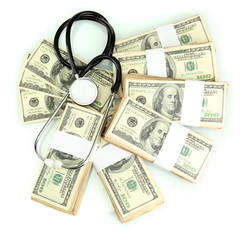 Healthcare cost concept: stethoscope and dollars isolated