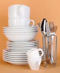 Clean white dishes on beige background