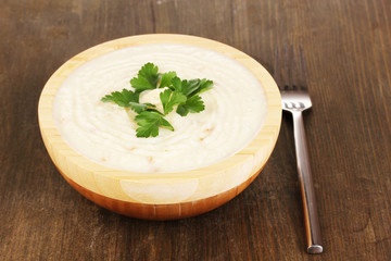 Mashed potatoes in wooden bowl on table close-up