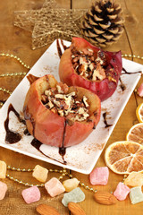 Baked apples on plate on wooden table