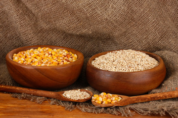 Raw corn and wheat in wooden bowls