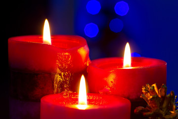 Christmas candles with blurry lights on background